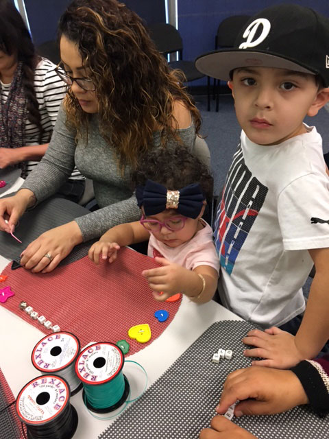 Families are making tactile placemats with hearts and shapes to touch and feel with their hands